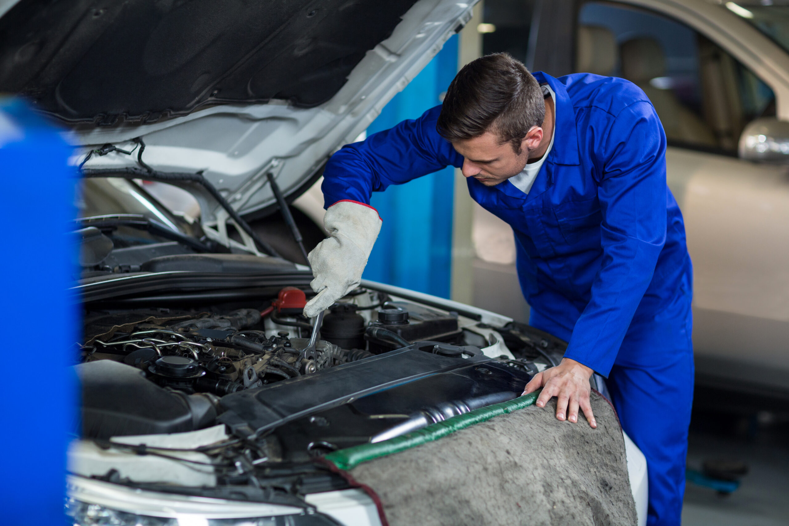mechanic servicing a car engine
